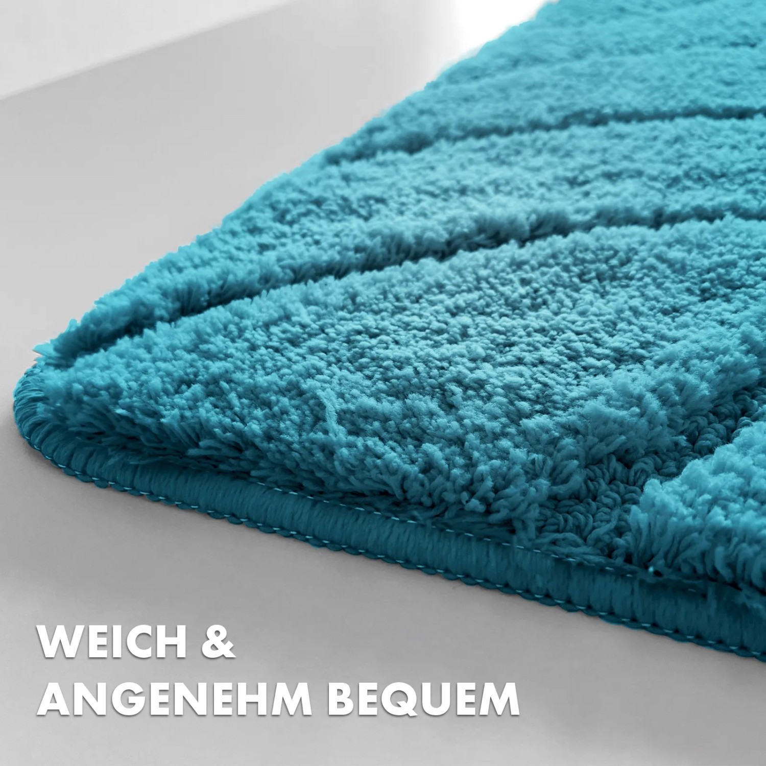 Türkise Karat Badematte Maris (60x120 cm) mit Blattstruktur, Detailaufnahme.