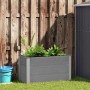 Graues vidaXL Garten-Hochbeet (100x50x54 cm) aus WPC, bepflanzt mit Grünpflanzen.