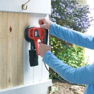 Black+Decker Exzenterschleifer KA191EK beim Schleifen einer Holztür.