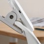 Weiße Philips LED-Tischleuchte Forys mit Clip-Halterung am Tisch befestigt.
