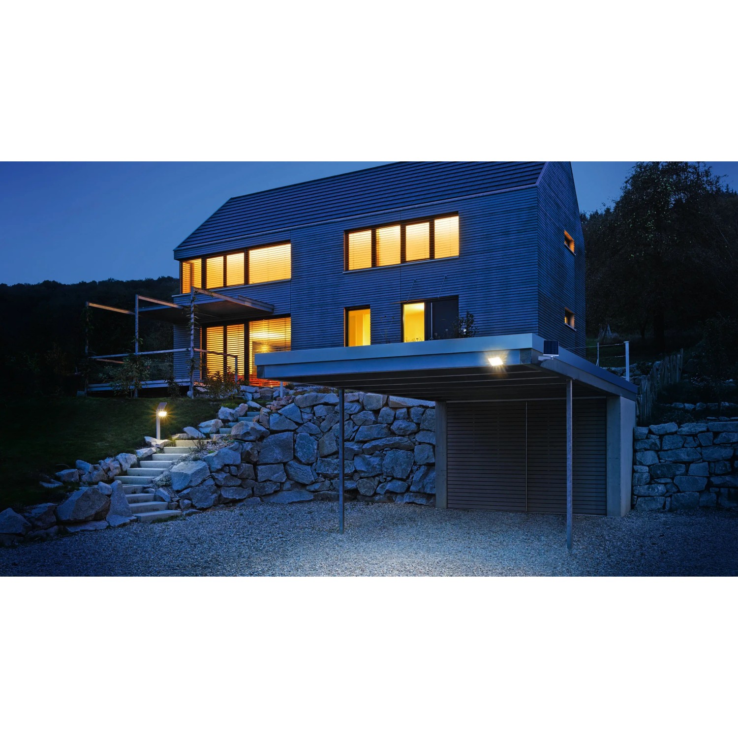 Anthrazitfarbene Steinel LED Solar-Wandleuchte mit Bewegungsmelder am Haus.