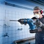 Bosch Professional Akku-Bohrhammer GBH 18V-34 im Einsatz beim Bohren in Fliesenwand.
