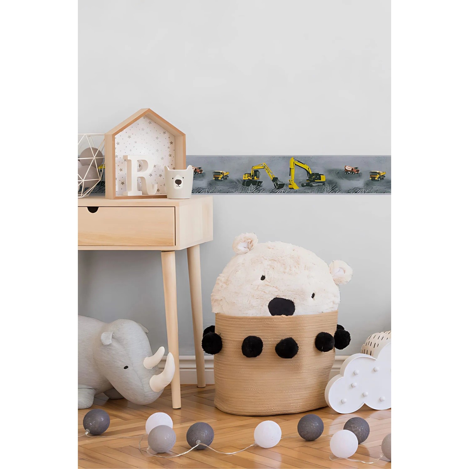 Kinderzimmer mit gelb-schwarzer PROFHOME Bordüre mit Baustellenfahrzeug-Motiv.