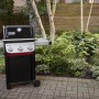 Schwarzer Weber Gasgrill E-310 Spirit 2025 mit 3 Brennern vor Gartenkulisse.