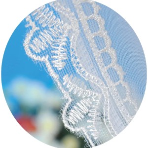 Detailaufnahme: Weiße Arsvita Gardine mit Satin-Stangendurchzug und filigraner Spitze.