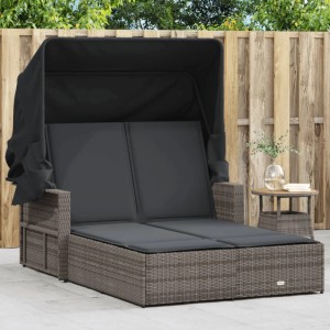 Graue Doppel-Sonnenliege aus Rattan mit Dach und Auflagen für den Garten.