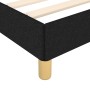 Detailansicht: Schwarzes Stoff-Bettgestell 80x200 mit Holzlattenrost und Füßen.