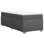 Dunkelgraues Boxspringbett 90x190 cm mit Matratze und weißer Auflage.