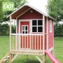 Rotes EXIT Loft 300 Holzspielhaus mit Rutsche und Treppe im Garten.