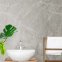 Kronoflooring Wandpaneel Rock the Wall Grey Atlantic Marble im Badezimmer mit Waschbecken und Handtuchhalter.