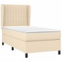Cremefarbenes Boxspringbett 90x200 cm mit Matratze und Kopfteil, Stoffbezug.