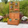Merxx Sichtschutz mit Kissenbox und Ablage aus geöltem Akazienholz im Garten.