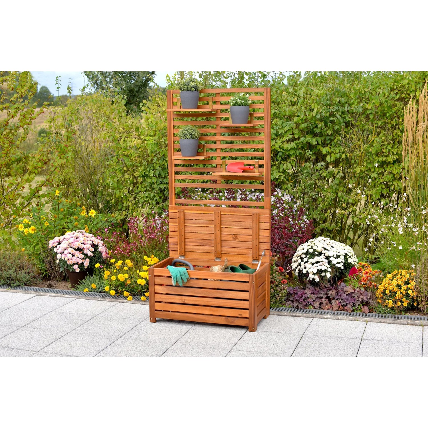 Merxx Sichtschutz mit Kissenbox und Ablage aus geöltem Akazienholz im Garten.