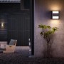 Anthrazitfarbene Philips Arbour LED Außenwandleuchte mit Up/Down Lichteffekt an einer grauen Wand.