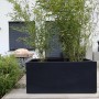 Anthrazitfarbener Vivanno Pflanzkübel Maxi (100x45x45 cm) mit Bepflanzung im Außenbereich.
