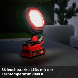 Einhell Akku-Outdoor-Lampe, rot-schwarz, leuchtet hell mit 36 LEDs und 7000 K Farbtemperatur auf dunklem Tisch.