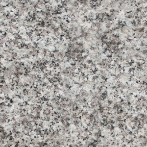 Nahaufnahme von Granit Mauersteinen: gesprenkelte Oberfläche in Grau, Weiß und Schwarz. Natürliche Stein-Textur.