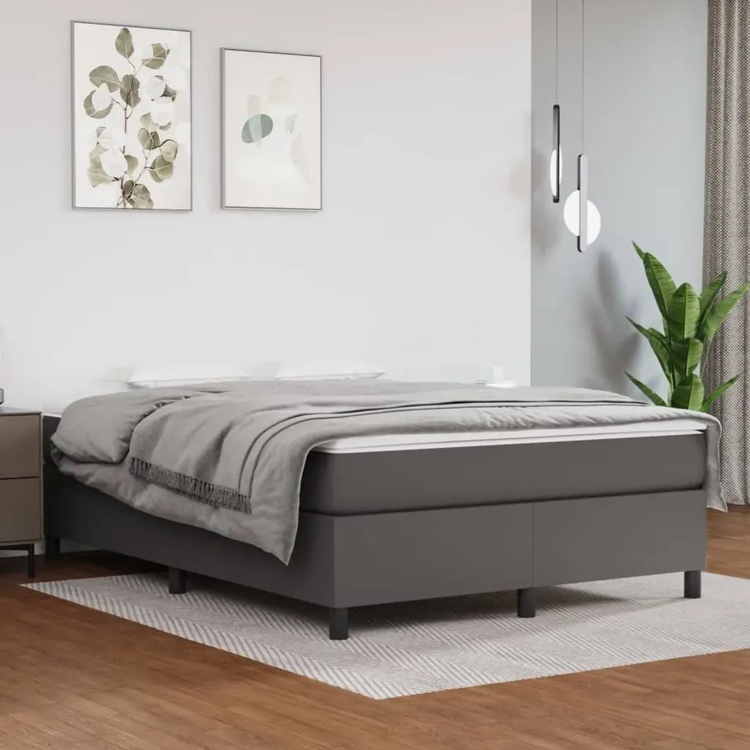 Graues vidaXL Boxspringbett (140x200 cm) mit Kunstlederbezug im Schlafzimmer.
