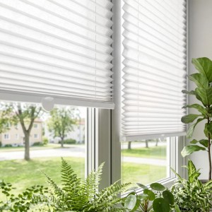 Weißes Plissee Klemmfix Faltrollo am Fenster, blickdicht und verspannt. Ideal als Sonnenschutz und Sichtschutz.