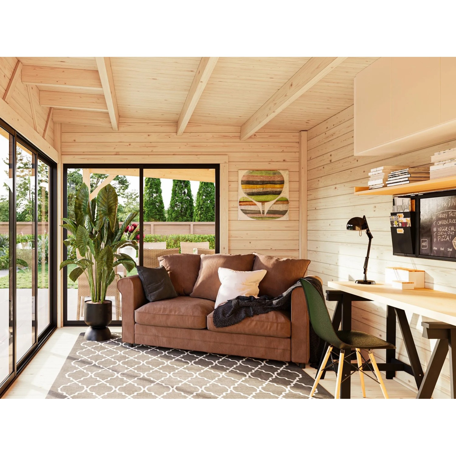 Innenansicht: Palmako Holz-Gartenhaus mit Pultdach als Wohnraum mit Sofa und Schreibtisch.