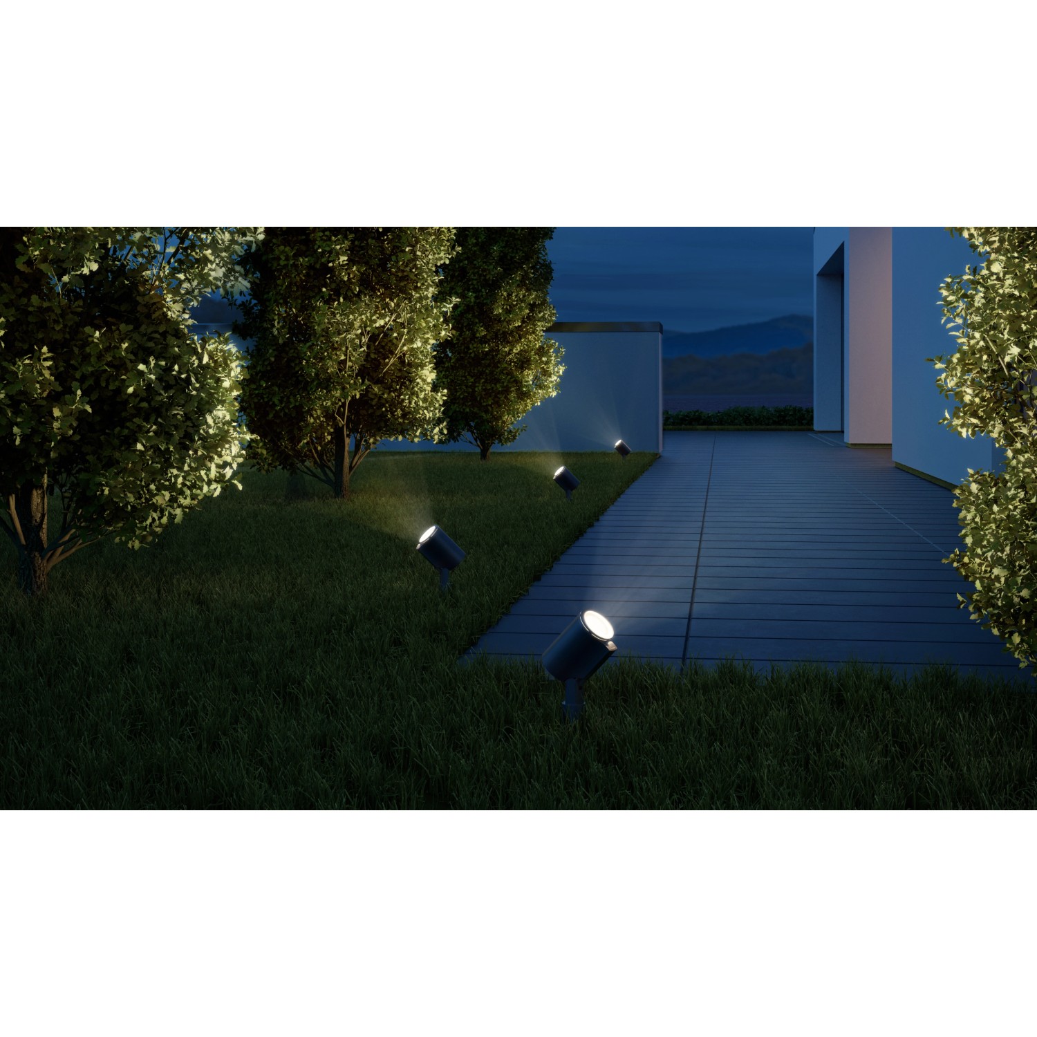 Anthrazitfarbene Steinel LED Gartenstrahler Spot Garden N beleuchten einen Gartenweg bei Nacht.