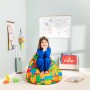 Mädchen sitzt auf buntem Sitting Point Sitzsack Bricks (120 l) im Kinderzimmer.