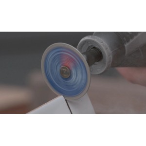 Rotierende Dremel Diamant-Trennscheibe Max EZ SpeedClic SC545DM schneidet präzise in weiße Keramikfliese.
