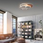 Moderne LED-Deckenleuchte Palma von Paul Neuhaus mit Holzdekor und silberfarbenen Ringen im Wohnzimmer.