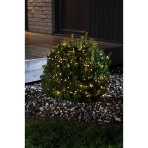 Konstsmide LED Büschellichterkette mit 240 warmweißen LEDs an einem Busch im Außenbereich.