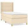 Cremefarbenes Boxspringbett 80x200 cm mit Matratze und Kopfteil aus Stoff.