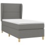 Dunkelgraues Boxspringbett 90x190 cm mit Matratze und Stoffbezug.