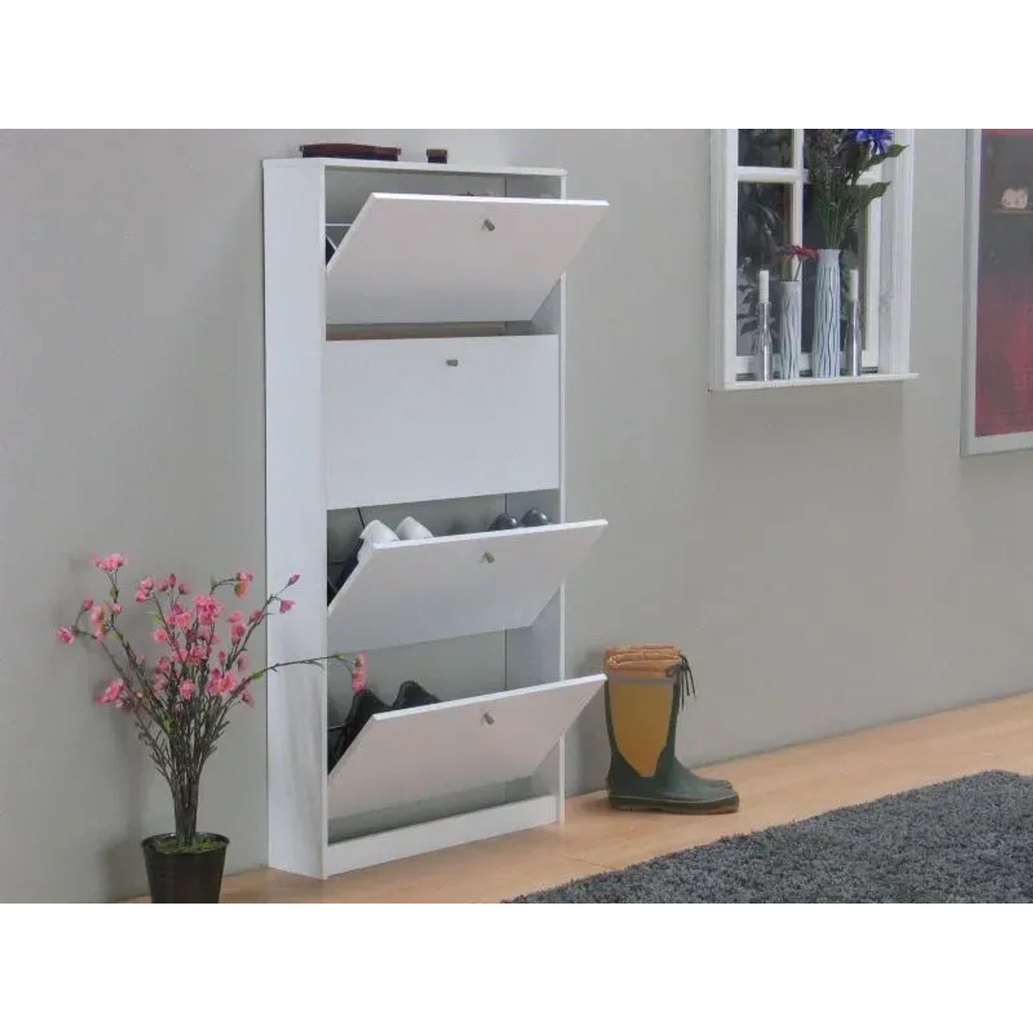 Weißer ebuy24 Schuhschrank Escape mit 4 Klappen, teilweise geöffnet, an Wand montiert.