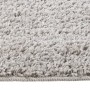 Detailansicht eines hellgrauen Shaggy-Teppichs (80x150 cm) mit rutschfester Unterseite.