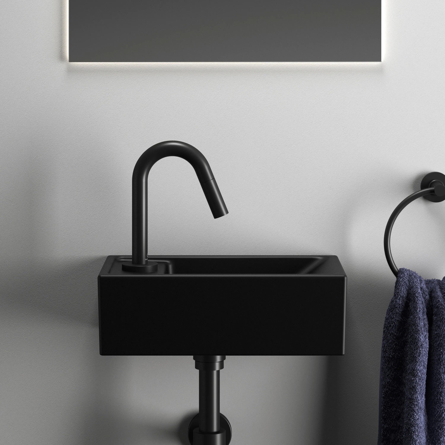 Schwarzer Ideal Standard Designsiphon G 1 1/4 unter einem Waschbecken.