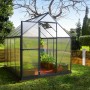 Graues Palram Canopia Gewächshaus 4,6 m² mit geöffneter Tür und Pflanzen im Garten.
