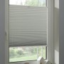 Weißes Schöner Wohnen Thermo-Plissee Ella (90x130 cm) am Fenster mit Dekoration.