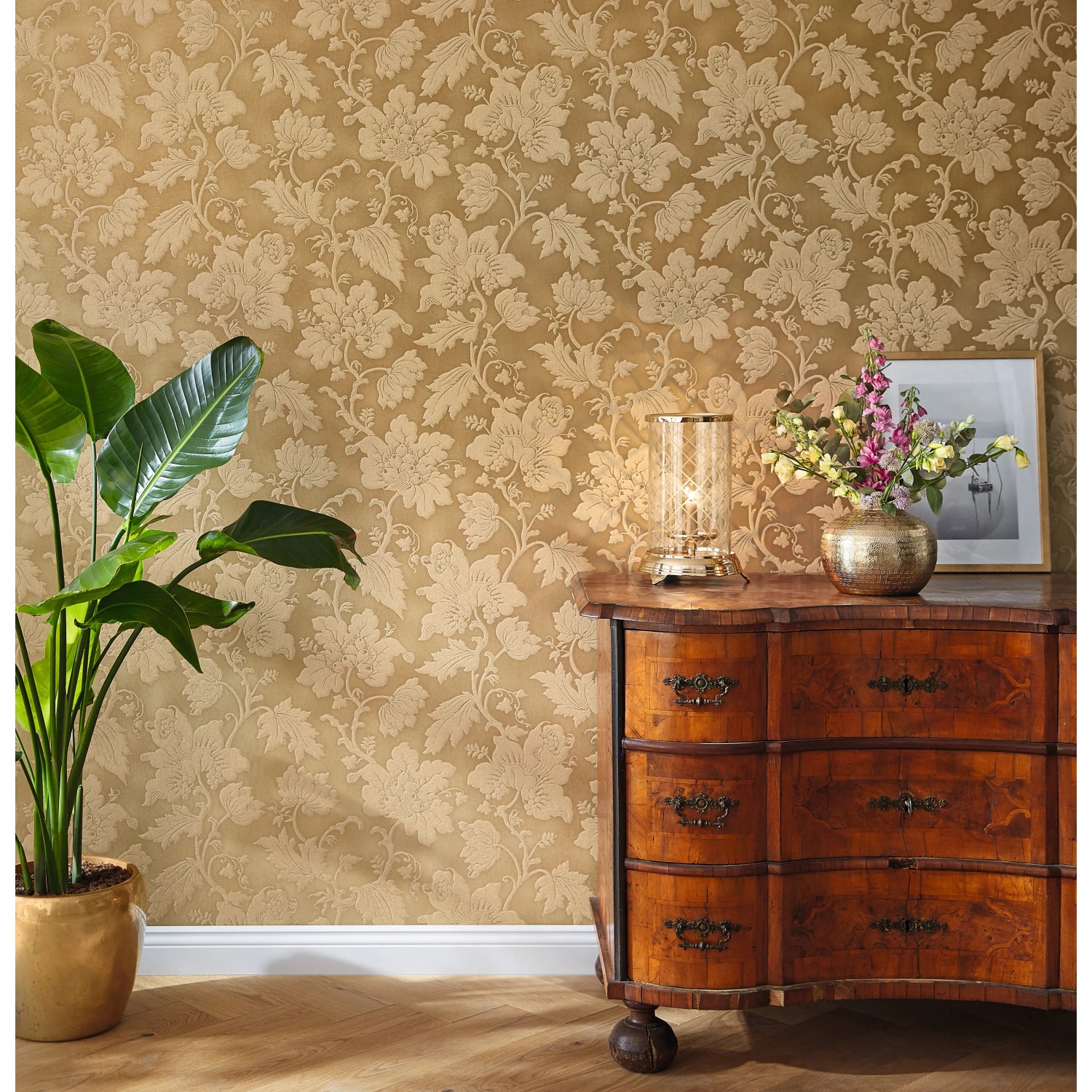 Rasch Vliestapete Trianon XIII 570472 in Mattgold mit Rankenmuster an der Wand.