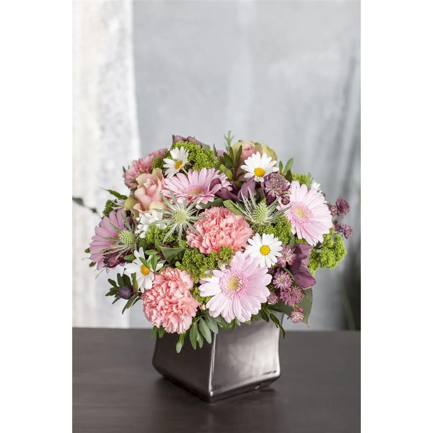 Blumenstrauß mit Wiesenmargeriten und rosa Blüten im Topf.