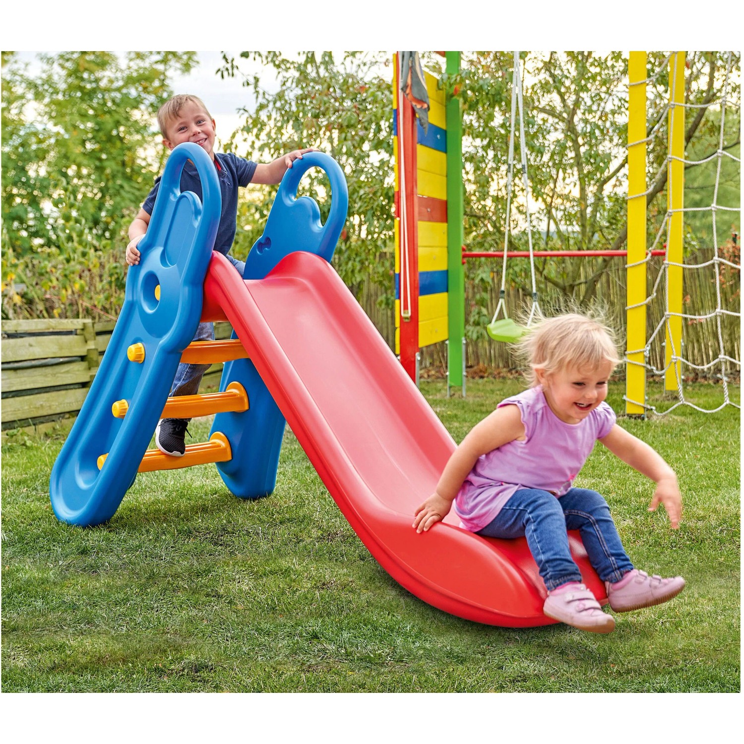 BIG Fun Slide Rutsche im Garten mit spielenden Kindern. Die Rutsche ist rot und blau.