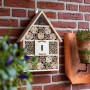 CULT at home Insektenhotel Braun, 41x28,5 cm, aus Holz mit Bambusröhrchen & Holzblöcken an Ziegelwand.