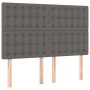 Graues vidaXL Boxspringbett Kopfteil mit Knöpfen und Holzfüßen.