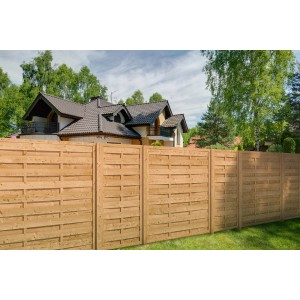 Honigfarbener Sichtschutzzaun aus Holz, 180x180 cm, vor einem Haus im Garten.