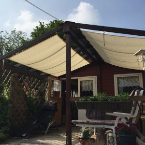 Peddy Shield Balkonbausatz mit elfenbeinfarbenem Sonnensegel (270x140cm) auf einer Terrasse.