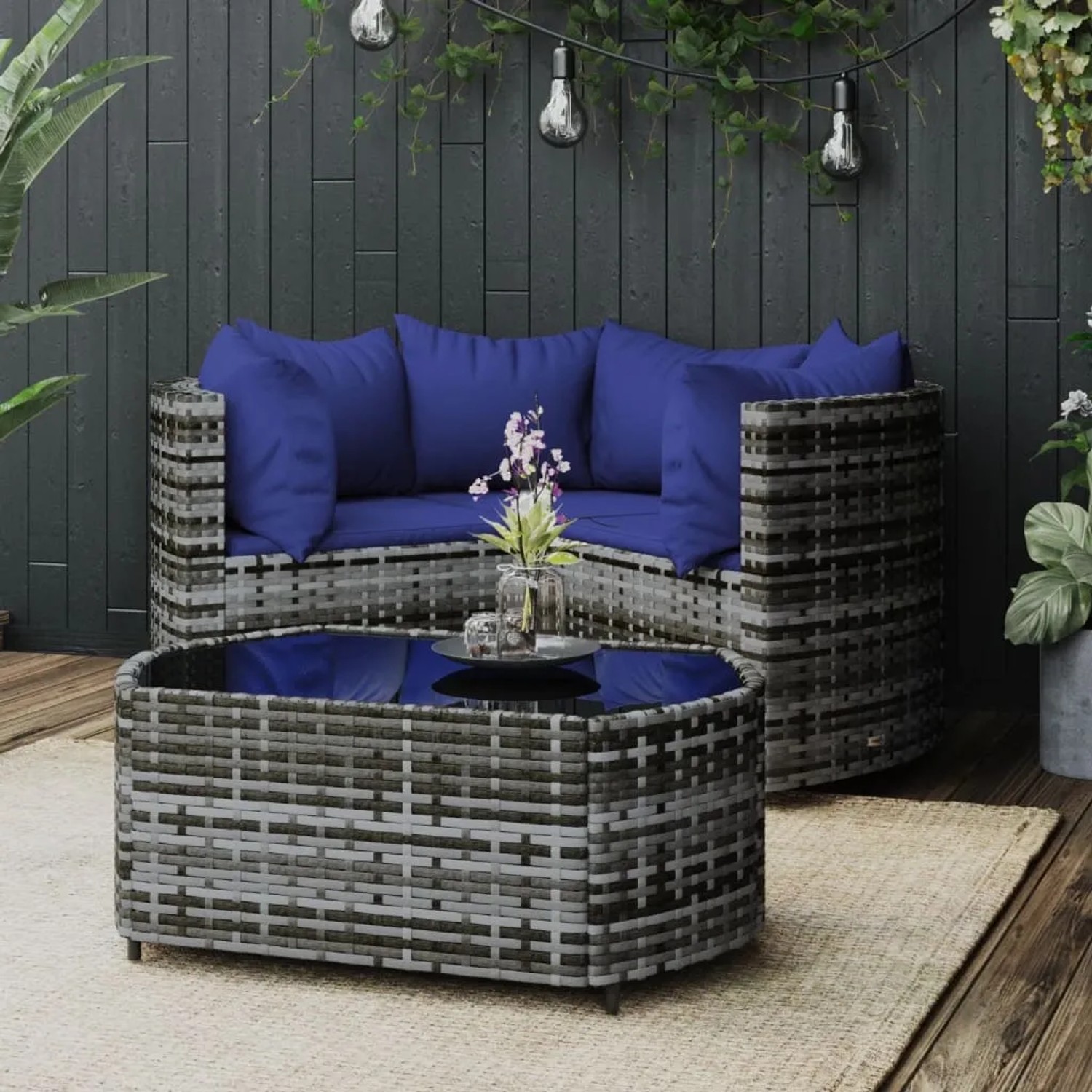 Graues 4-tlg. vidaXL Garten Lounge Set aus Rattan mit blauen Kissen und Tisch.