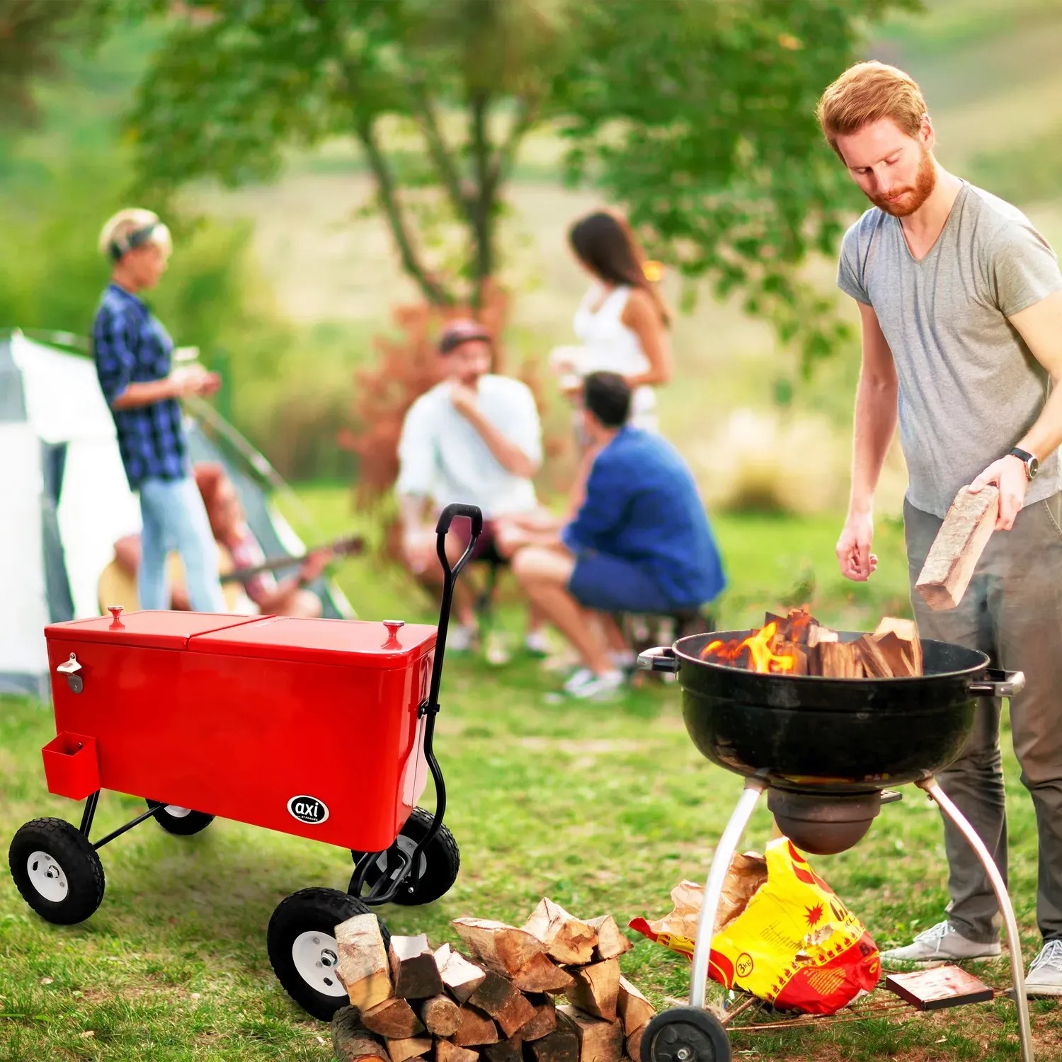 Roter Axi Bollerwagen mit Kühlbox (76 l) beim Grillen mit Freunden im Garten.