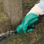 Hand mit LUX Garten Nitrilhandschuh S beim Grasschneiden. Gartenbekleidung für sicheres Arbeiten.