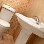 Weißes Kerra Retro Stand WC mit Softclosing Sitz und niedrigem Spülkasten in klassischem Vintage Design im Bad.