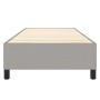 Hellgraues Boxspringbett 100x200 cm aus Stoff. Bett mit Lattenrost und schwarzen Füßen.