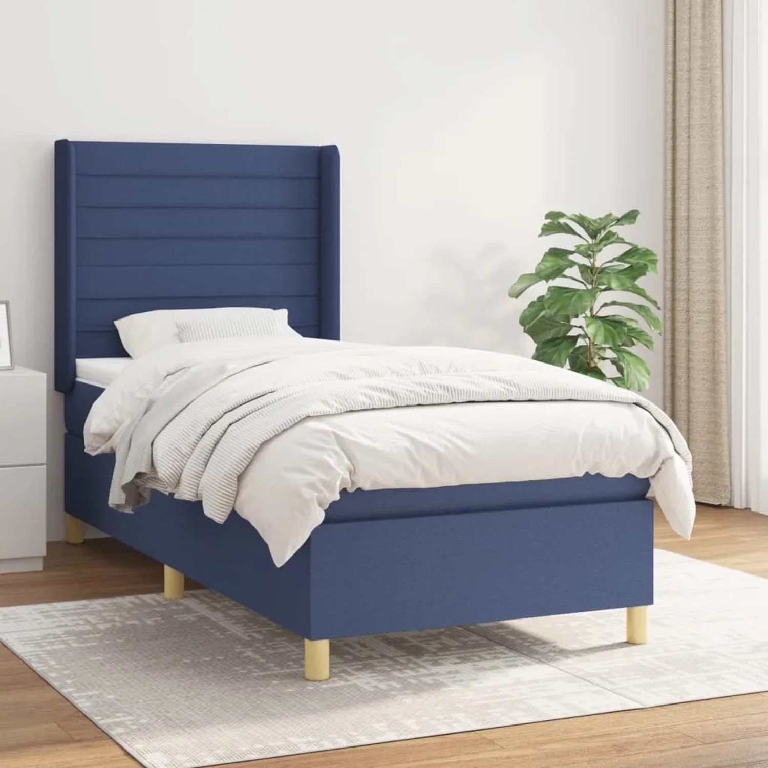 Blaues Boxspringbett 90x190 cm mit Matratze und Stoffbezug.