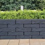 Mauer aus Diephaus Menhire Mauersteinen in Basalt, Bruchsteinoptik für Gartenmauern.